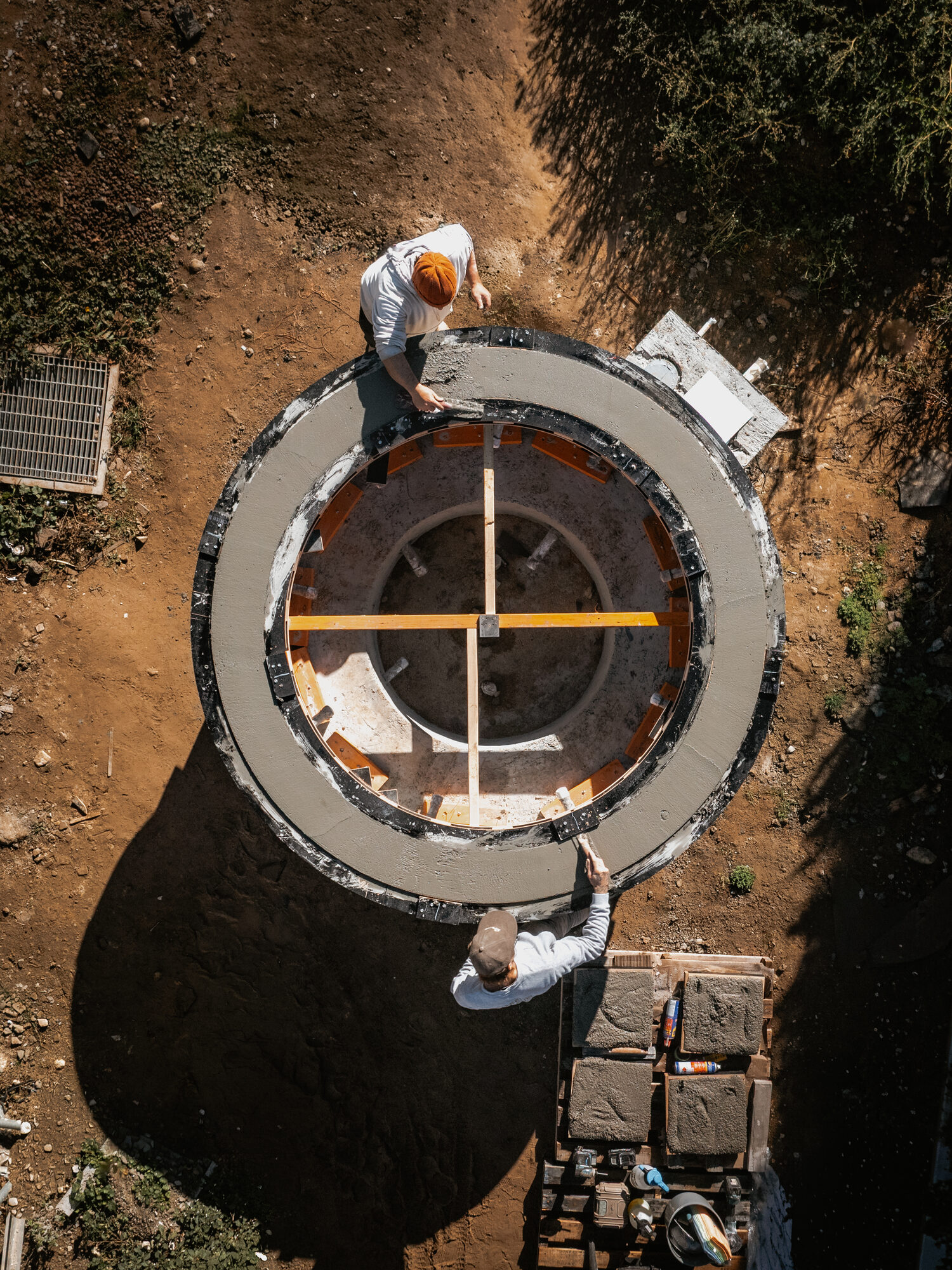 Overhead view of workers finishing a circular concrete ring