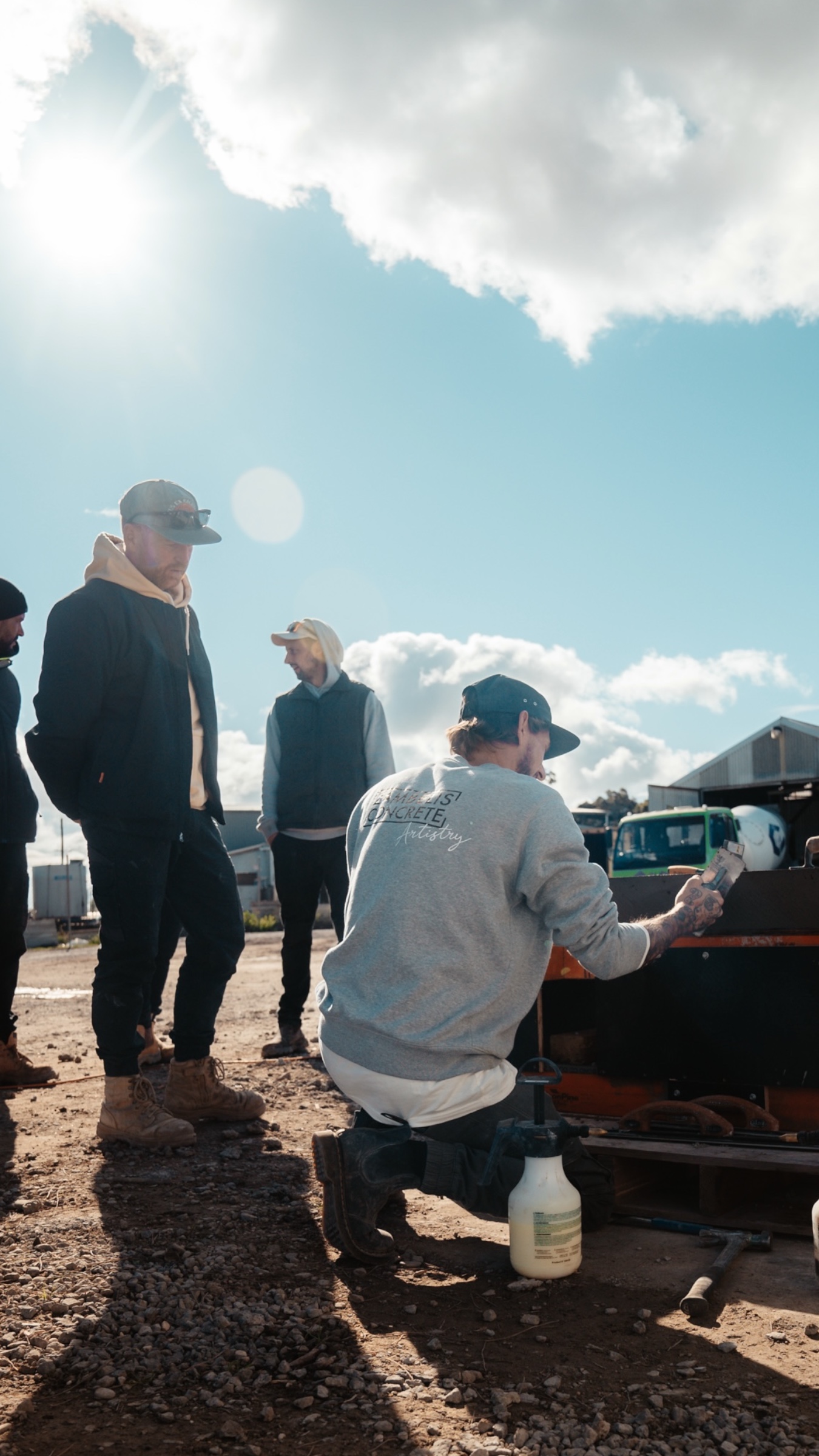 Outdoor concrete demonstration watched by colleagues