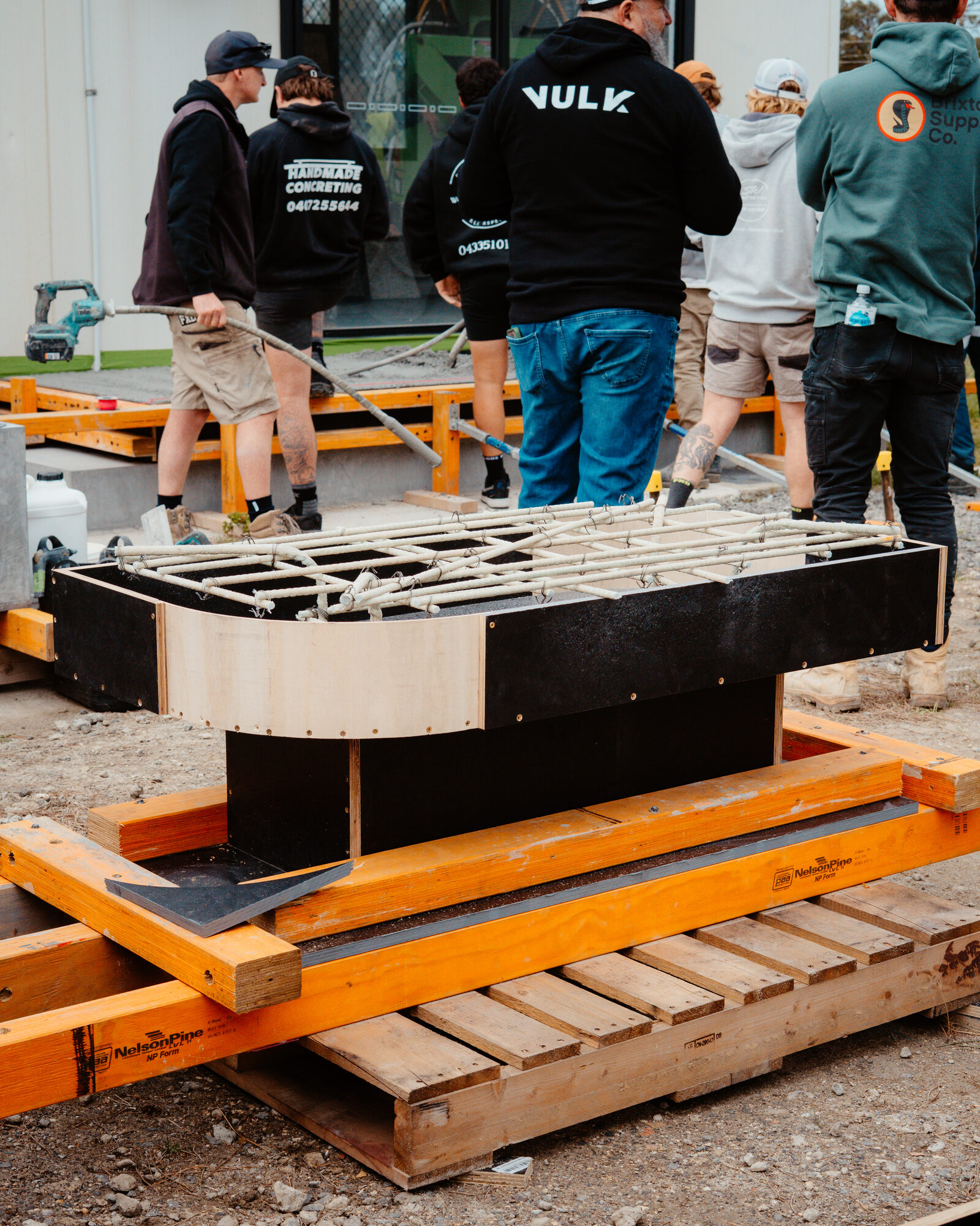 Curved formwork with rebar cage and observing cohort