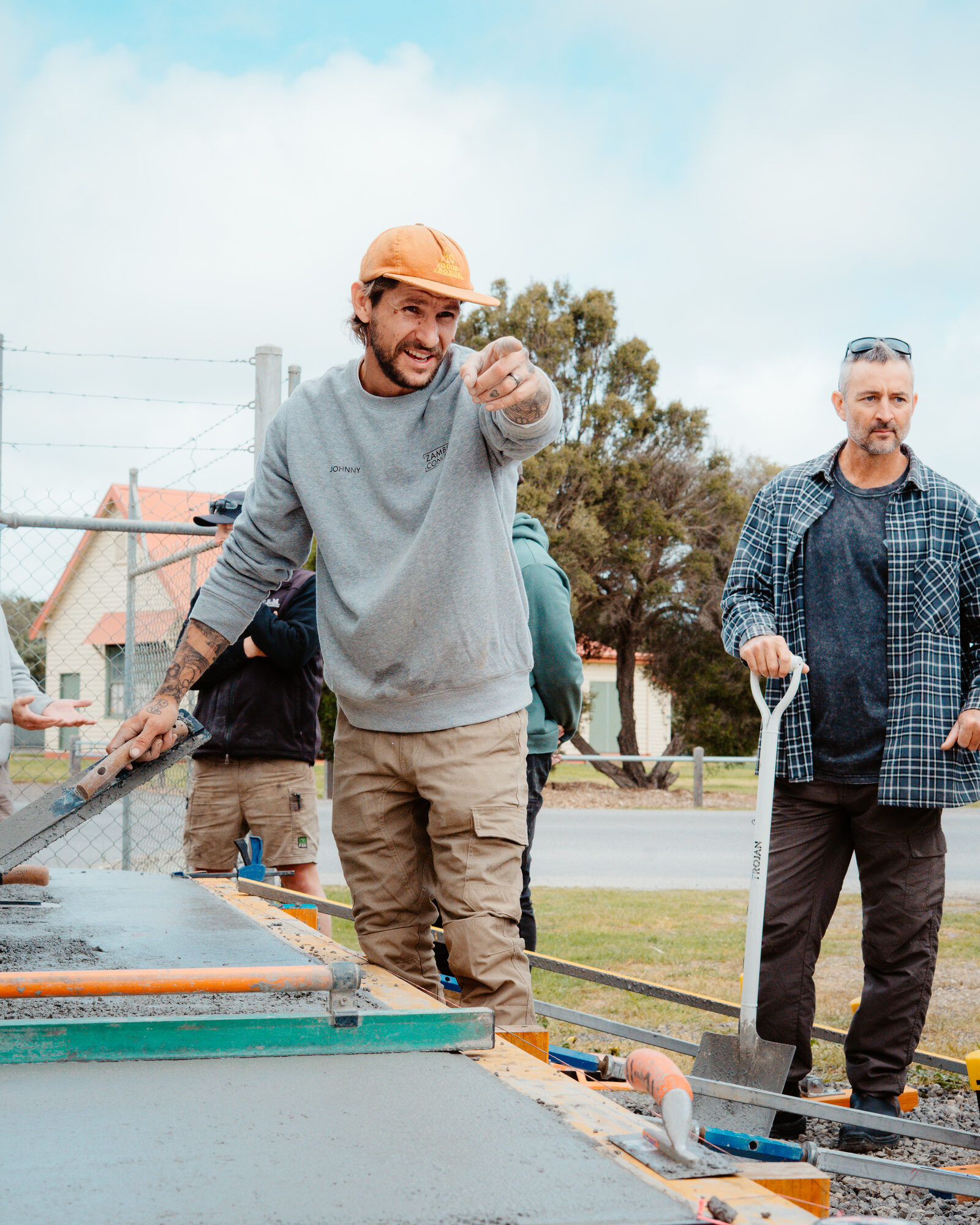 Instructor directing a fresh concrete pour on site