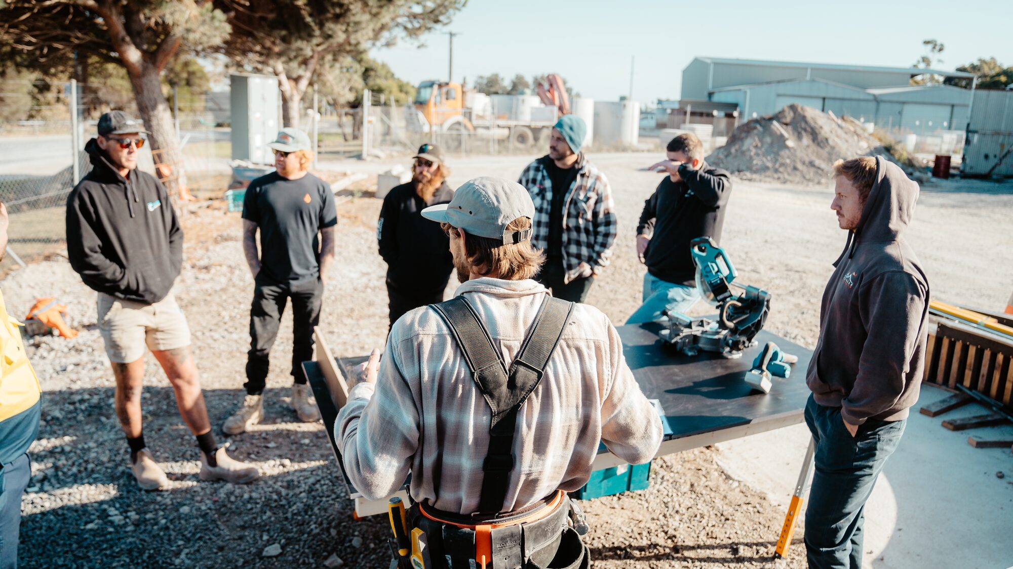 Outdoor tool briefing around a miter saw table